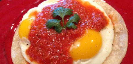 Huevos Rancheros, sunny side up eggs with salsa.